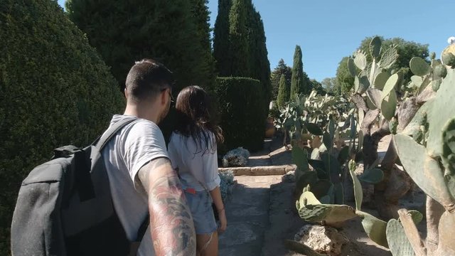 Happy couple walking in Balchik botanical garden. Young tourists exploring new destinations during summer holiday