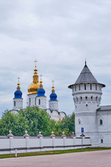 Fototapeta na wymiar The Tobolsk Kremlin is white-stone kremlin in Siberia, Russia. Wall and tower, domes of St. Sophia-assumption Cathedral