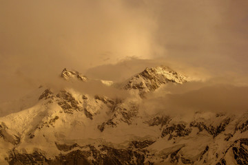 nanga parbat mountain in golden light with clouds 
