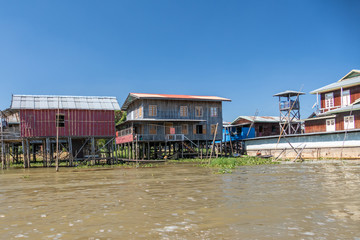 Fototapeta na wymiar Floating village houses along Inle Lake in Burma