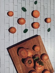 Carrot slices on wooden planks and white gingham paper.