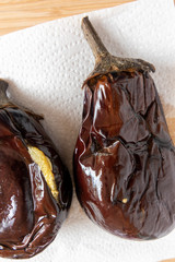 roasted aubergines soaking on kitchen paper 