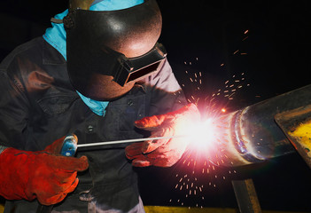 The welder is assembling valve to the pipe line with arc machine Welding process, The welder wears...