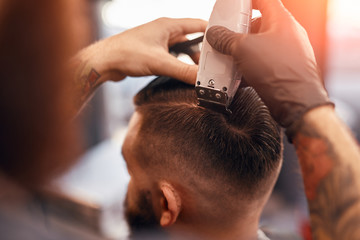 Bearded man getting haircut in barbershop