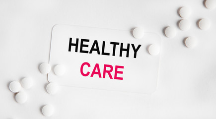 On a broken sheet of paper the inscription is a care, next to a white tablet and stethoscope.