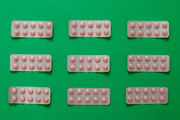 Drug pillls in blister pack on table with colorful background