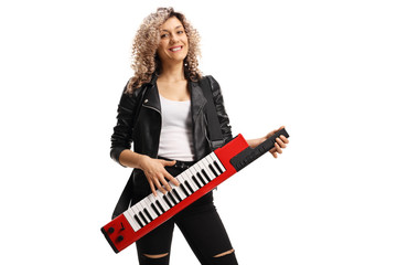 Fototapeta premium Female musician with a curly blond hair playing a keytar synthesizer