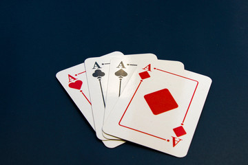 Four aces and chips, card game, cards on the table. Poker and blackjack.