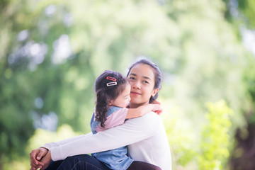 Fototapeta premium Portrait of happy loving mother and her baby outdoors, Asian girl lifestyle. Asia mother's day concept
