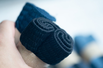 Hand holding of rolled folded dark men underwear