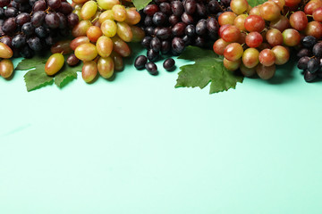 Fresh ripe grape on mint background, space for text