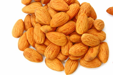 group of brown almond seed high vitamin on wooden spoon isolate on white background.