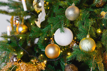 Christmas toy ball hanging on a branch of spruce. New year tree decorated with a garland