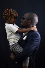 Father holding up his daughter happily