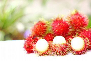 the delicious sweet fresh rambutan tropical fruit and rambutan peel show infront of with blur background.