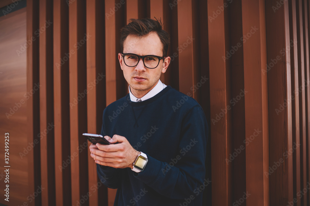 Poster half length portrait of confident man in cool spectacles chatting in social networks with friends vi