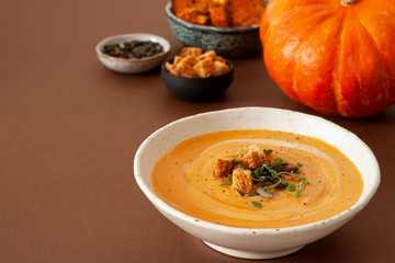 Pumpkin soup with thyme herb, cream and pumpkin seeds.