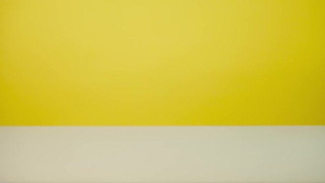 Eat a sandwich. Time lapse of a bite-size sandwich on a yellow background.