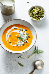 Creamy pumpkin soup with pumpkin seed and fresh herbs.
