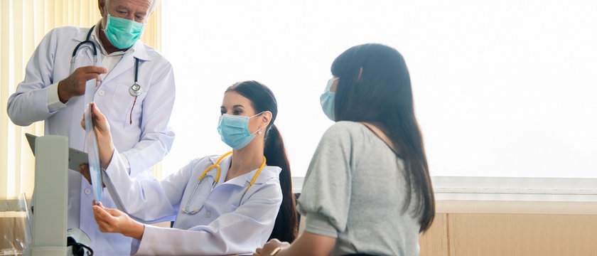 Female Doctor Looking At Mammogram Film Explain Mammogram Results Of Breast Test From X-ray Scan  To Patient