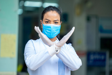 Doctor wearing protective mask to Protect Against Covid-19 with stop symbol,Quarantine due to Coronavirus,Coronavirus Covid-19 concept.