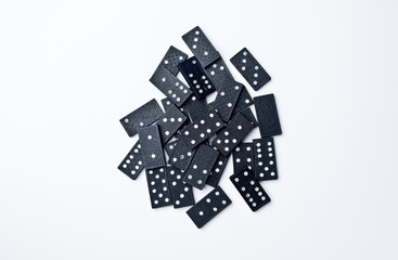 The domino board game. Black chips. White background