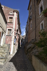 A narrow street among the old houses of Maierà, a rural village in the Calabria region.