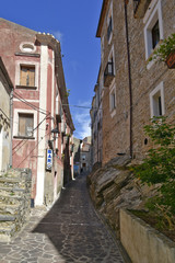 A narrow street among the old houses of Maierà, a rural village in the Calabria region.