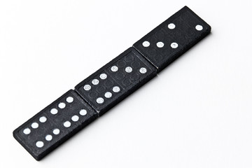 The domino board game. Black chips. White background