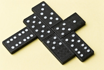 Domino board game. Black chips. Yellow background