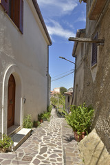 A narrow street among the old houses of Maierà, a rural village in the Calabria region.