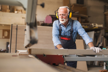 A carpenter operating on a woodworking machine