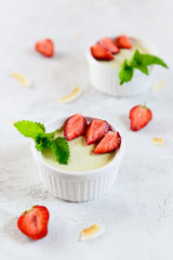 Avocado panna cotta with strawberries and mint in white bowls. Sugar, lactose, gluten free. Healthy...