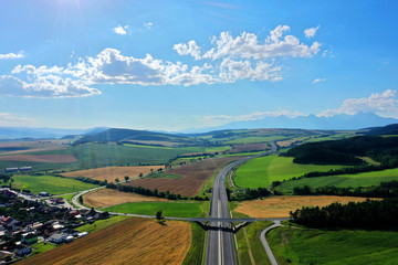 Fototapeta na wymiar Aerial view of the highway and a view of the Tatras in the village of Spissky Stvrtok in Slovakia