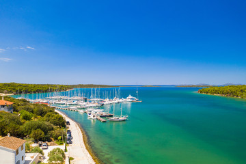 Marina in Veli Rat on Dugi Otok island on Adriatic sea coastline in Croatia, aerial view from drone, beautiful seascape