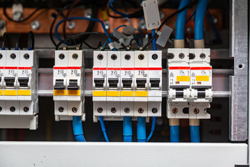 Circuit breakers close-up and matching wires of different thicknesses. Horizontal orientation. 