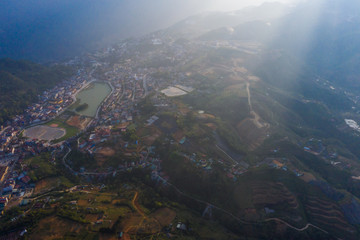 Aerial view of panorama landscape at the hill town in Sapa city, Vietnam with the sunny light and sunset, mountain view in the clouds