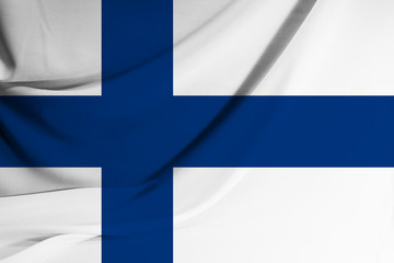Obraz premium The national flag of Finland on fabric texture background. Flag image for design on flyers, advertising.
