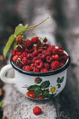 Cup of fresh raspberries. Concept for healthy nutrition. Rustic background. Close up.