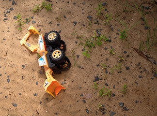 toy cars on the sand after rain on a summer day