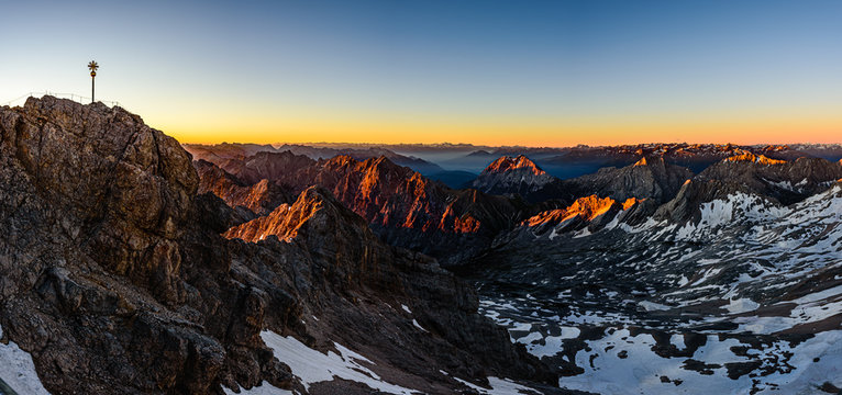 A beautiful and colorful sunrise on the summit of the highest mountain in Germany, Zugspitze at 2962m. 