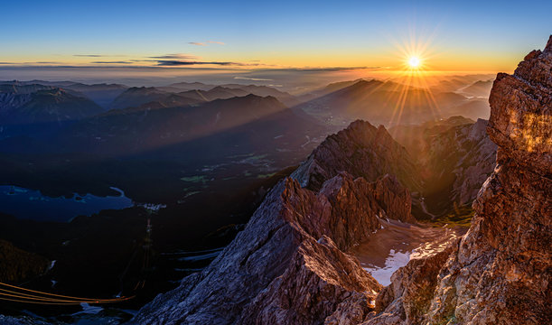 A beautiful and colorful sunrise on the summit of the highest mountain in Germany, Zugspitze at 2962m. 
