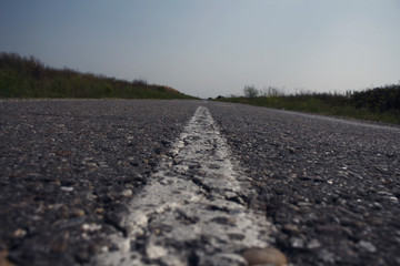 Textured Asphalt Road and white line closeup shot