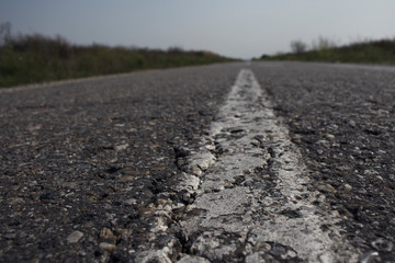 Textured Asphalt Road and white line closeup shot