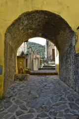 A narrow street among the old houses of Orsomarso, a rural village in the Calabria region.