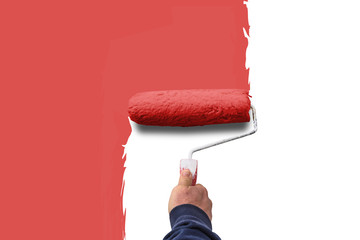 hand holds paint roller and painting a wall

