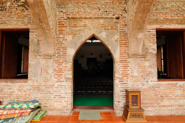 PATTANI, THAILAND -JULY 10, 2014: Historic Kru Se mosque which is made of bricks with round pillars. The mosque represents a unique Islamic civilization of the Kingdom of Pattani in Thailand.