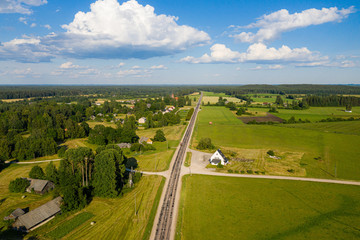 aerial view on rural countryside road through forest, agricultural lands and villages