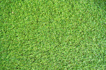 Fototapeta premium Bright plastic grass floor carpet texture in an indoor stadium
