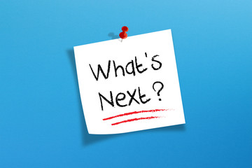 White note paper with what's next on blue background